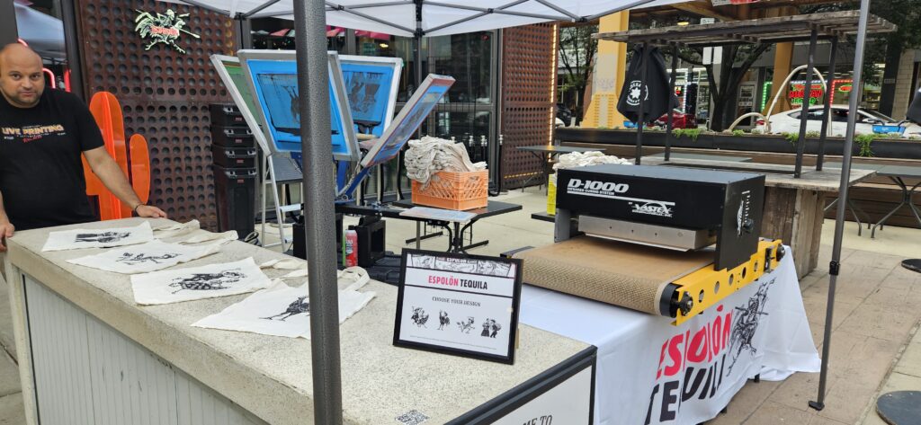 live print event activations for Espolon Tequila featuring a table display and screen print setup with 4 design options