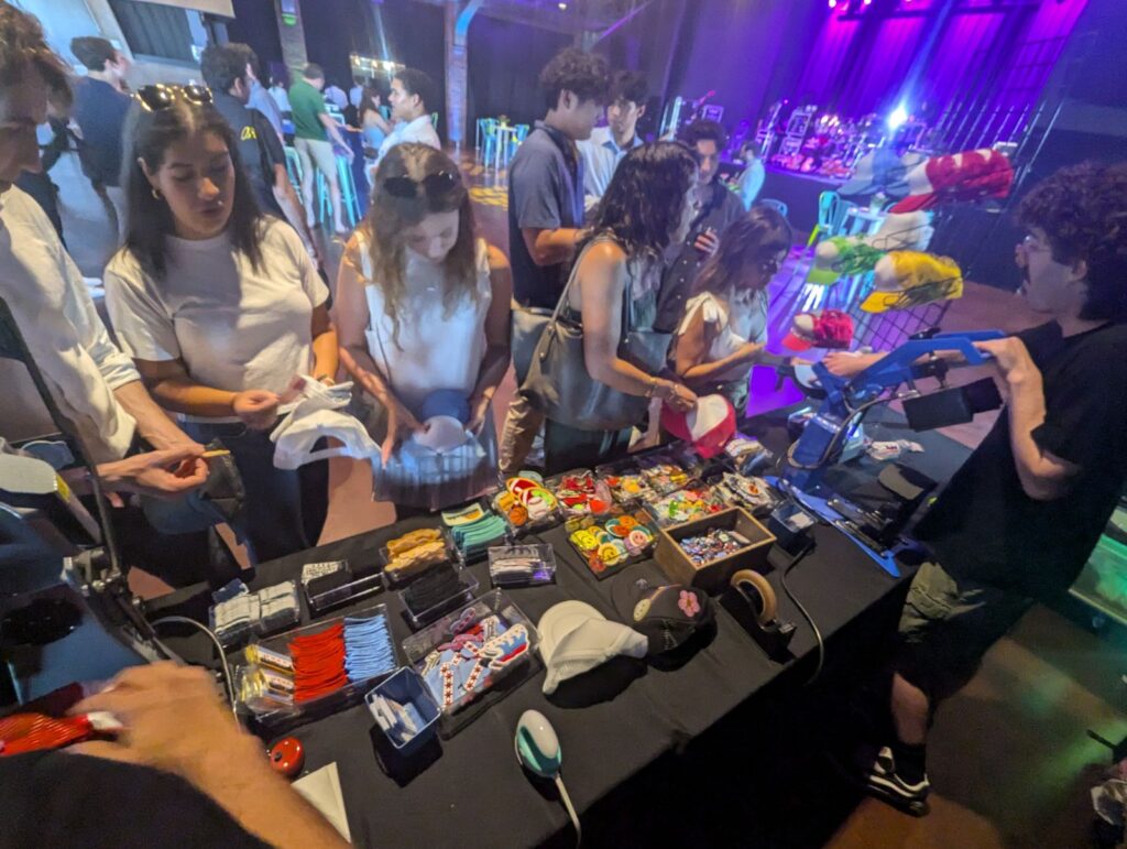 Attendees pickng out patches at a customized hat bar Experiential Activation at the lakefront theatre